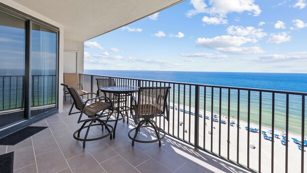 A balcony with a view of the ocean, furnished with chairs and a table. - Fantastic Rates! Gulf Front 3Br/2Ba*12th Floor*Phoenix X Unit 1213 (Orange Beach)