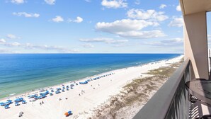 A beach view from a balcony with umbrellas and beach chairs. - Fantastic Rates! Gulf Front 3Br/2Ba*12th Floor*Phoenix X Unit 1213 (Orange Beach)