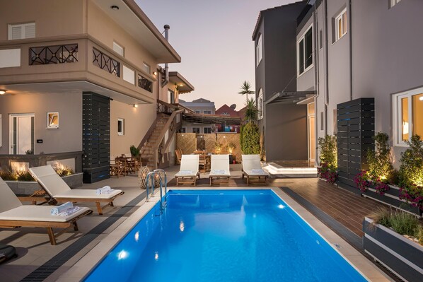 Seasonal outdoor pool, open 9:00 AM to 8:30 PM, pool umbrellas