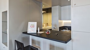 A modern bathroom with a dark countertop, a sink, and a mirror. There is a framed welcome sign and a small decorative item on the countertop. - Attico Vista Mare sul Porticciolo di Camogli by Wonderful Italy (Camogli)
