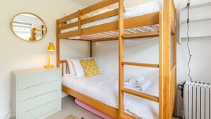 A bunk bed room with a dresser, a mirror, a lamp, and a radiator. - 3 Bed in Mortehoe (oc-pines) (Mortehoe)
