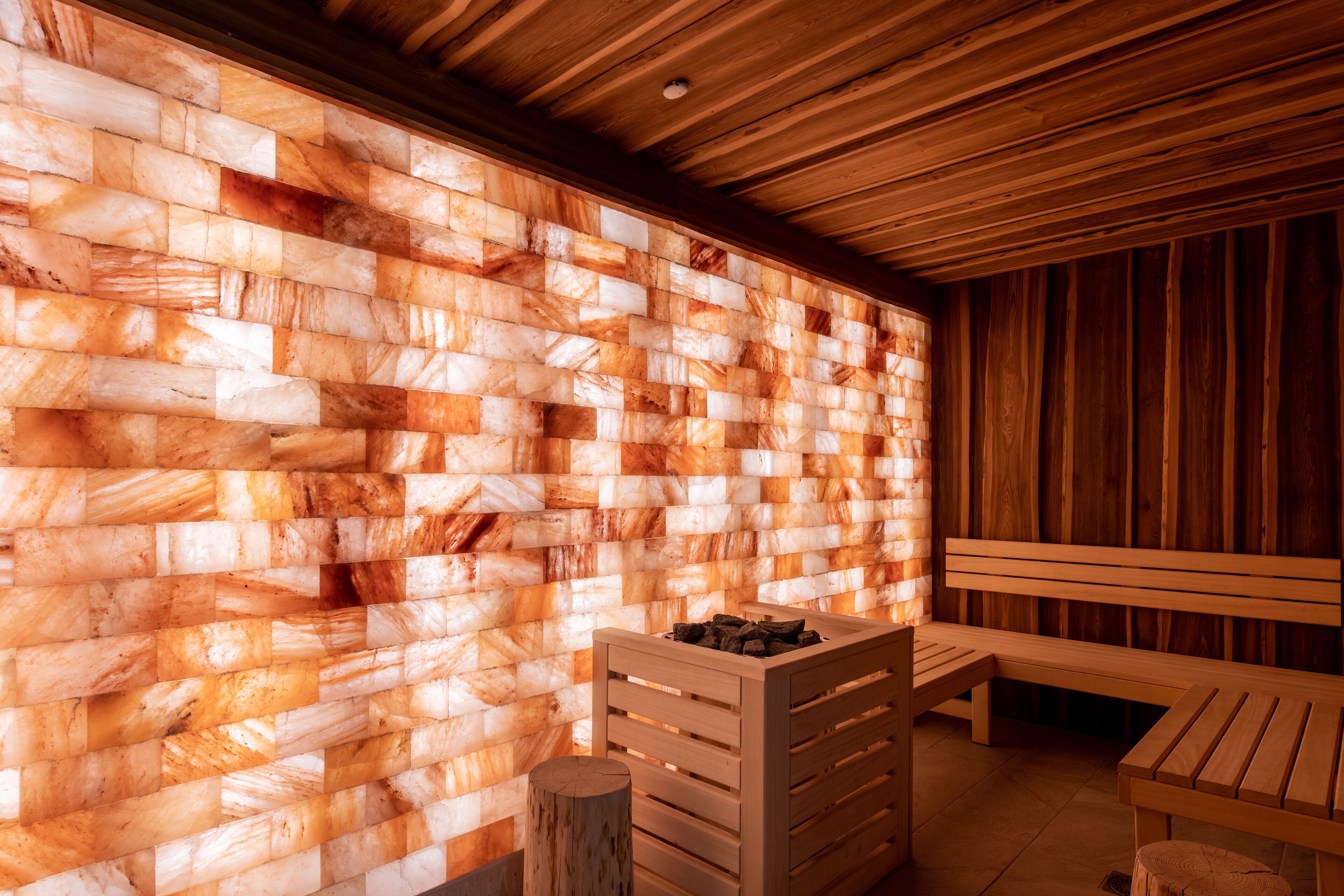 A sauna room with a wooden bench and a bench with a bench seat.
