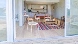 A modern interior with a kitchen, dining area, and seating space.