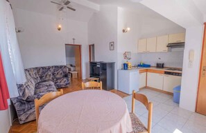 Cozy living space with a dining area, sofa, and kitchenette.