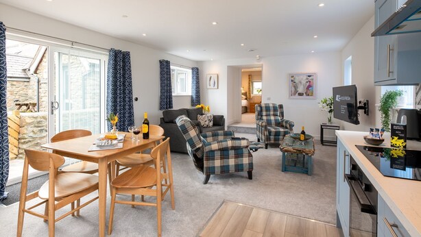 Eine moderne Wohnung mit Essbereich, Wohnzimmer und Küche.