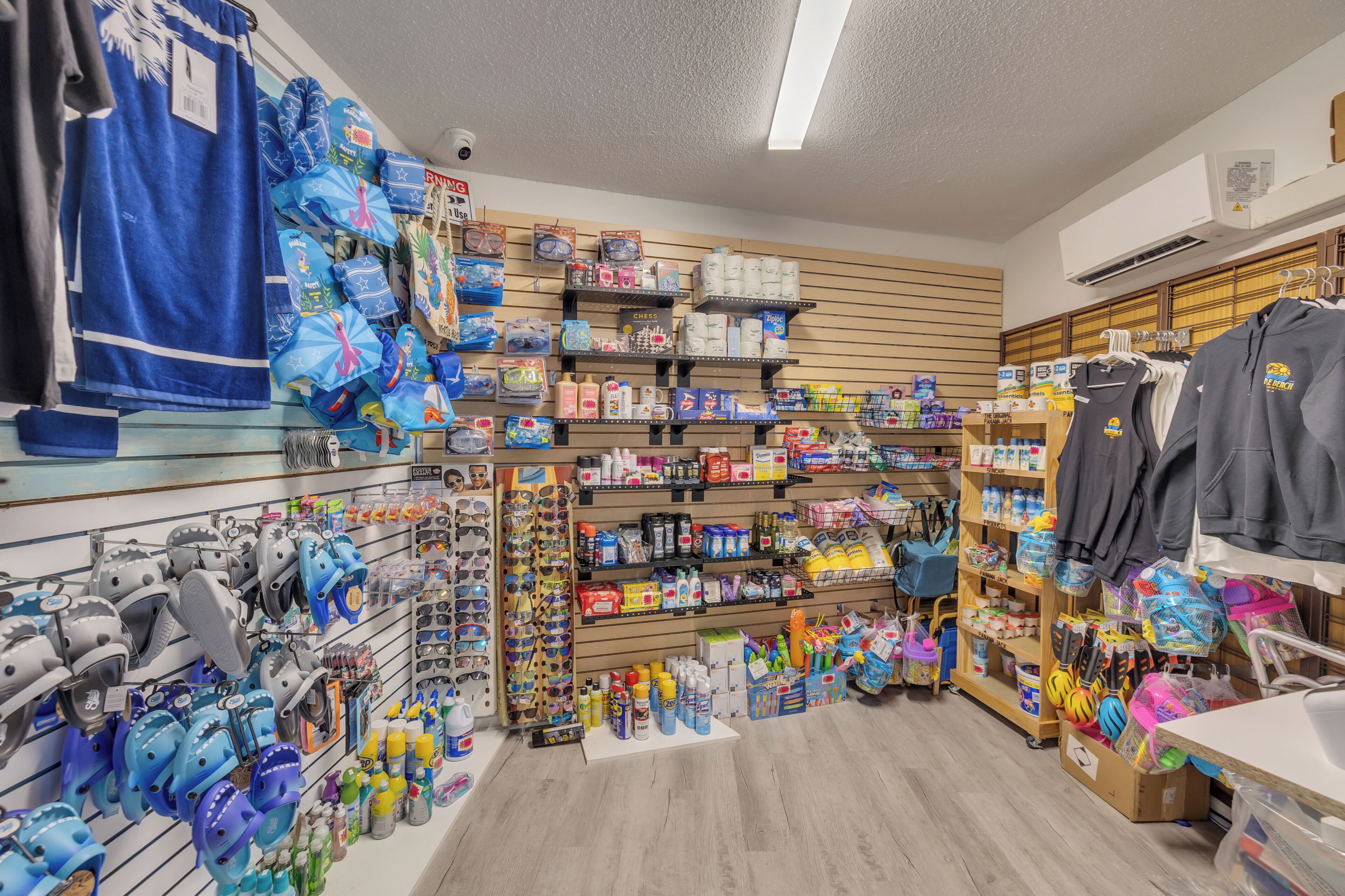 A retail store with shelves stocked with various products, including footwear, household items, and clothing.