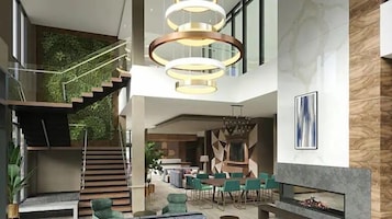 Un interior espacioso con escalera, zona de estar y comedor.