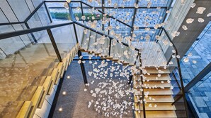 A modern staircase with glass railings and wooden steps, leading to an upper level. - DoubleTree by Hilton Shenzhen Airport (Shenzhen)