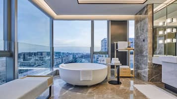 Deluxe Suite, 1 King Bed | Bathroom | Separate tub and shower, bathrobes, slippers, towels