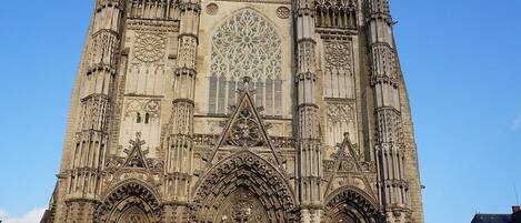 A Gothic cathedral with two towers, large rose windows, and intricate stone carvings.