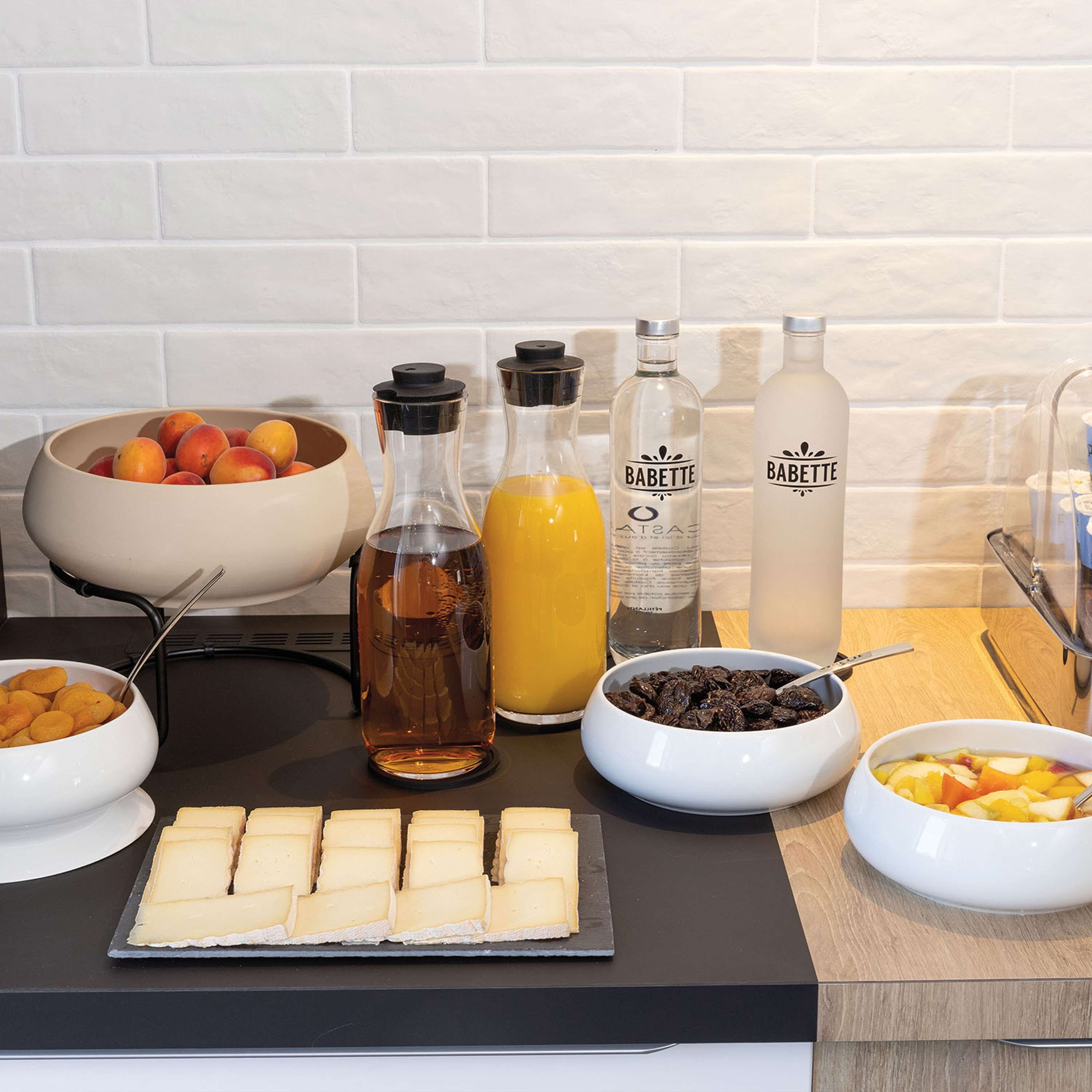 A breakfast buffet with various food items and beverages.