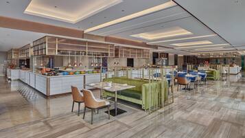 A modern restaurant with a central bar area, seating arrangements, and a polished floor.