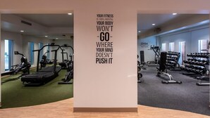 A gym with various exercise equipment, including treadmills, stationary bikes, and weight machines. - The Morgan Resort & Spa (Simpson Bay)