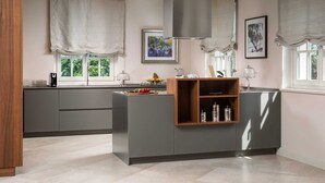 A modern kitchen with a central island, grey cabinetry, and a window with a view of greenery. - Villa Palazzo di Zara with Pool (Vabriga)