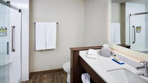A modern bathroom with a shower, toilet, and sink. - Holiday Inn Express Canton Potsdam (Canton)
