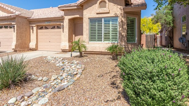 A residential house with a garage, a driveway, and a landscaped garden with rocks and plants. - Ahwatukee/Foothills-Golfer's Paradise! Desert Vacation Retreat/Gated Community! (Phoenix)