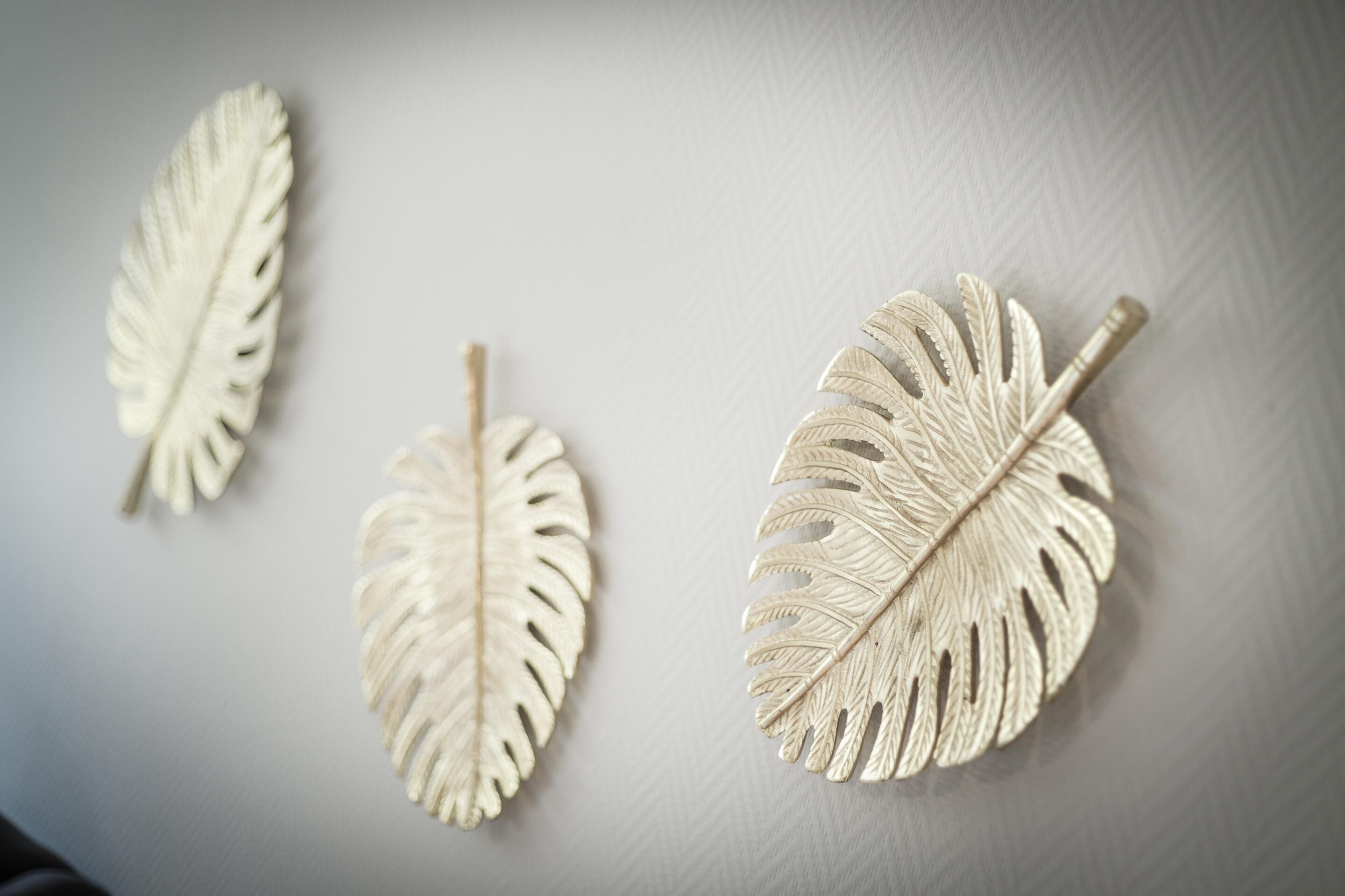 Three wall-mounted decorative leaves.