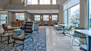 A spacious lobby with a high ceiling, comfortable seating areas, and large windows providing natural light. - Residence Inn by Marriott Reading (Wyomissing)