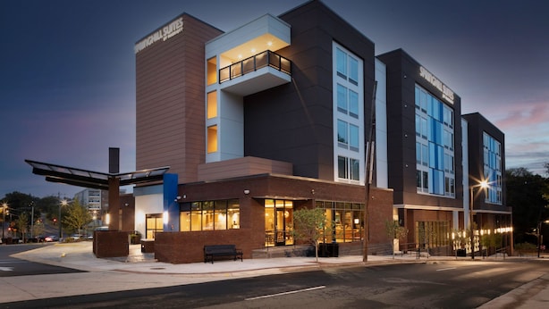 A modern hotel with a prominent entrance, multiple floors, and a balcony on the second floor. - SpringHill Suites by Marriott Durham City View (Durham)