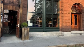 A brick building with a large window and a sign that reads "BAR AND BOARD BISTRO".