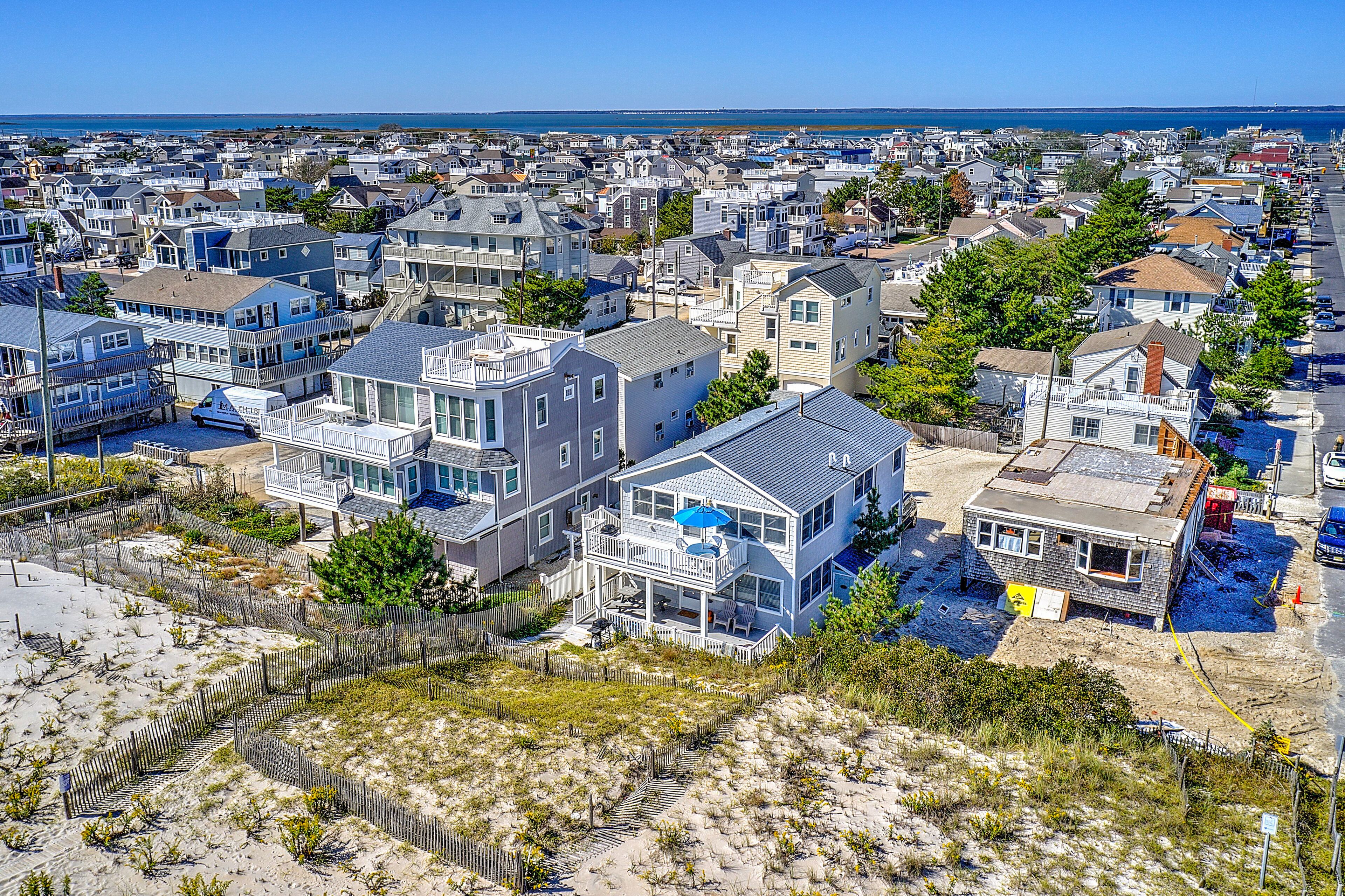 A coastal residential area with houses, some with balconies and waterfront views.
