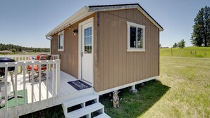 A small wooden cabin with a porch, a door, and a window. - Cabin "The Eagles Nest" (Custer)