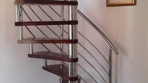 A spiral staircase with metal railings and wooden steps, leading to an upper floor. - Immaculate 4-Bed House in Lumbarda (Lumbarda)