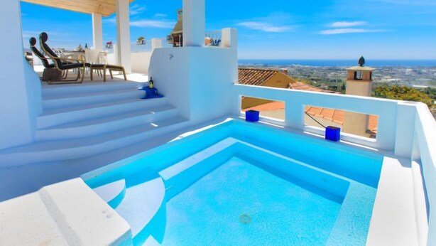 A rooftop pool area with a clear view of the cityscape.