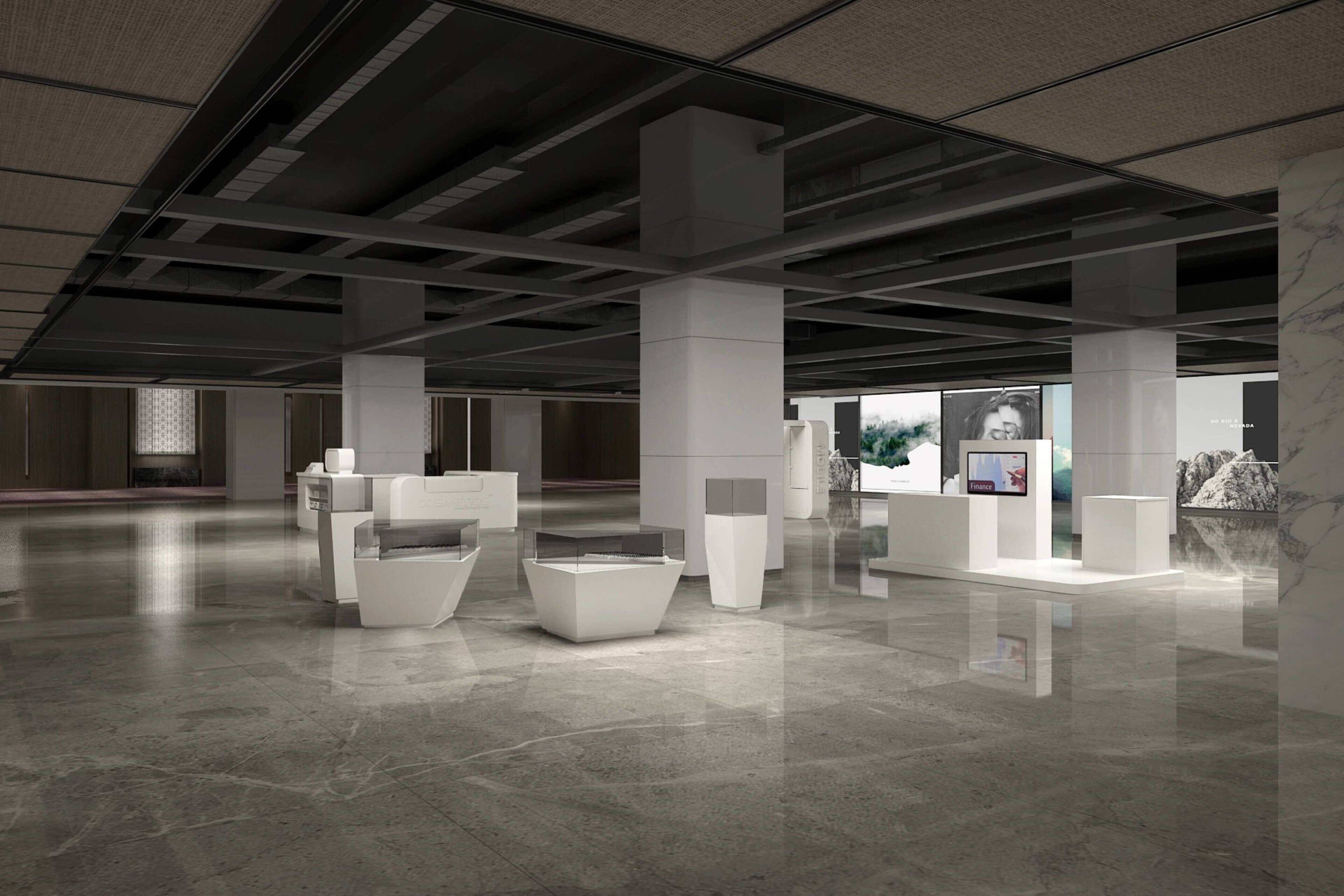 A spacious, modern interior with high ceilings and a polished floor, featuring several white display units and seating areas.