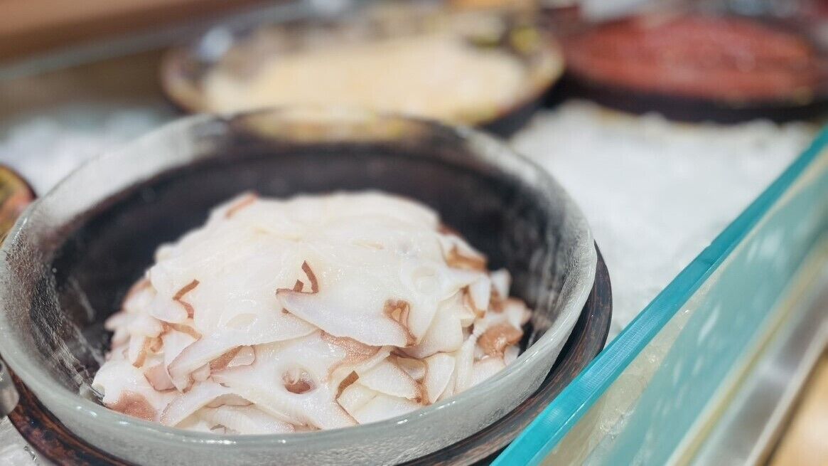 A bowl of sliced white fish, likely prepared for cooking or serving.