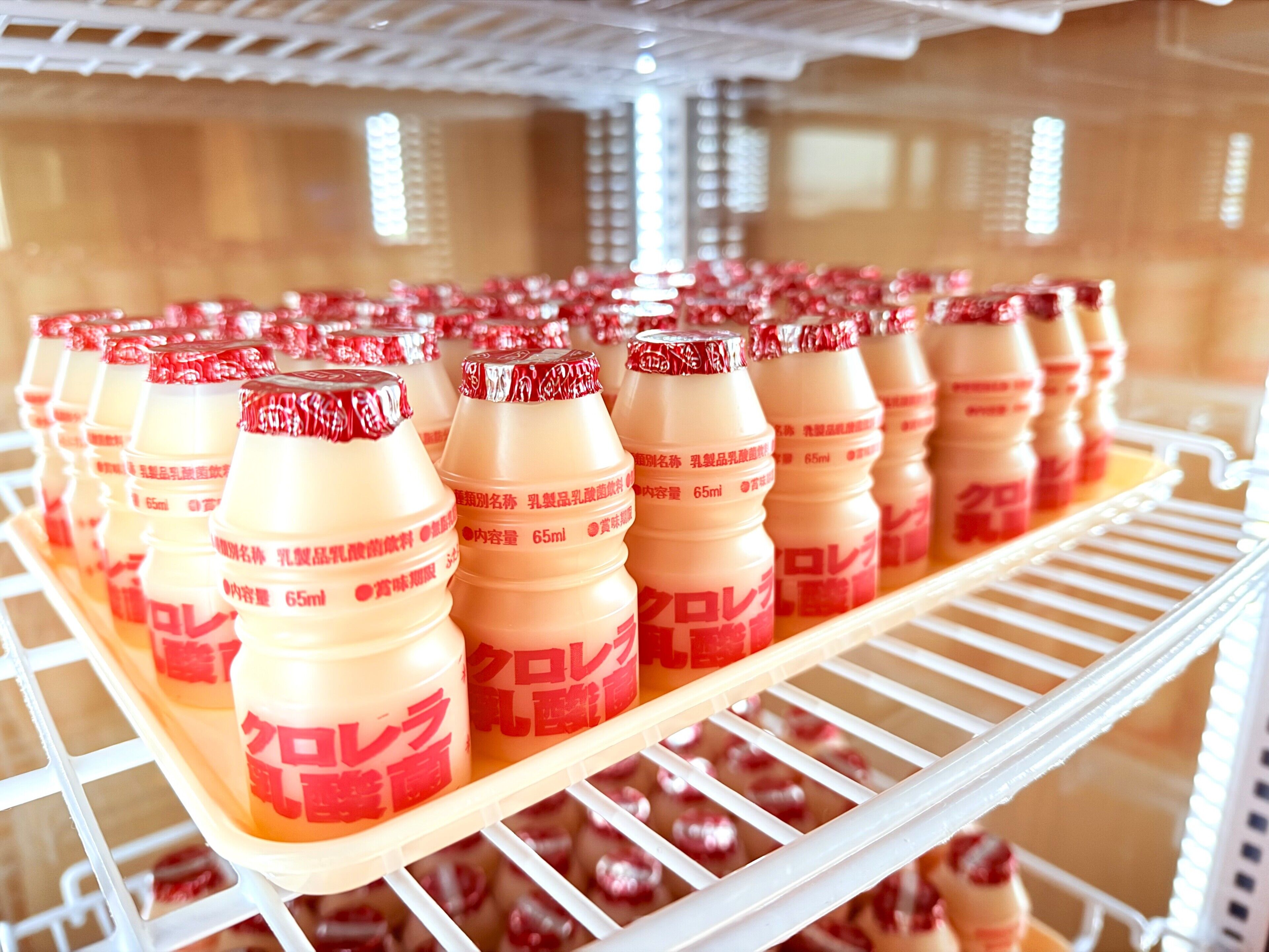 A refrigerated display of bottled beverages on a shelf.