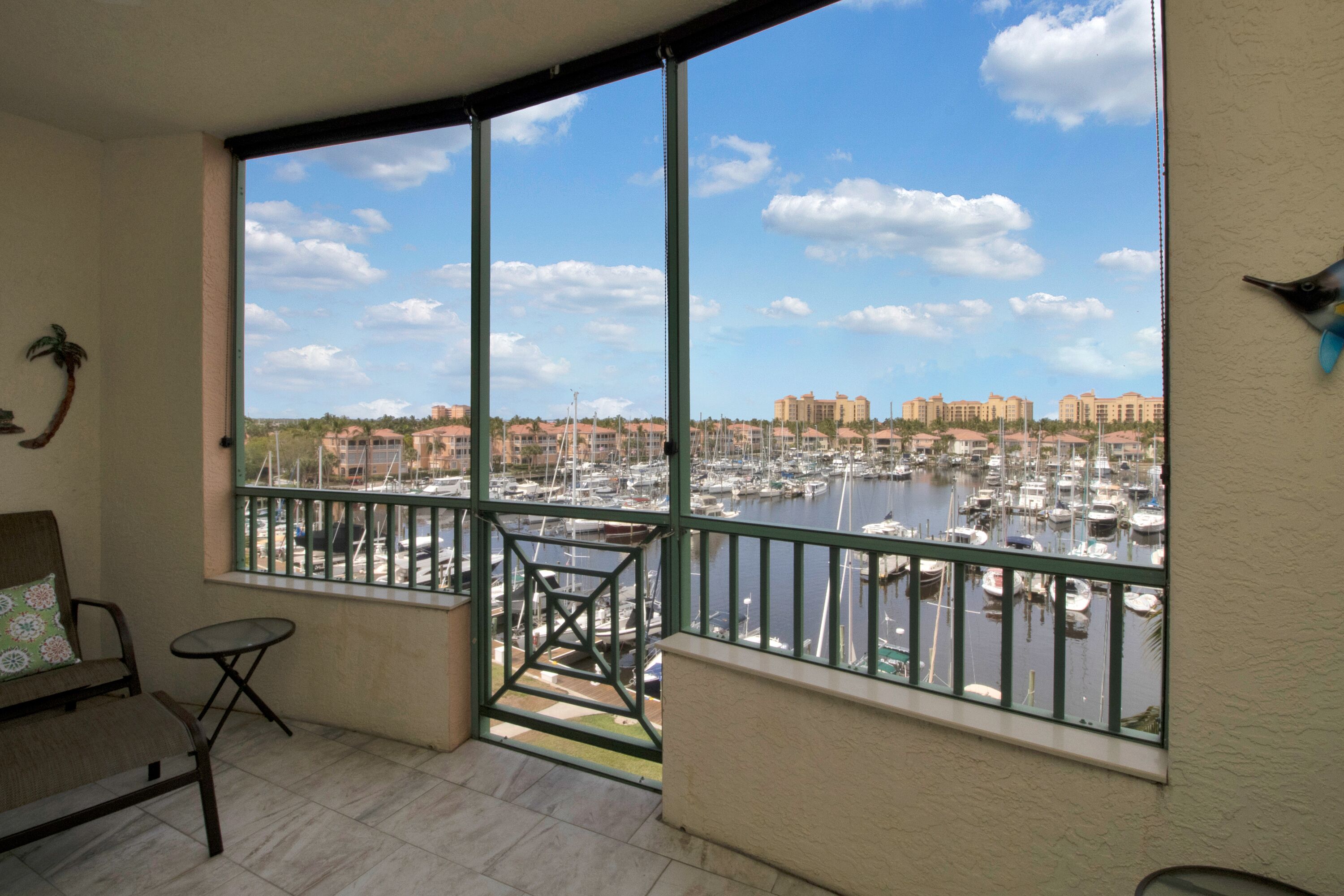 A balcony with a view of a marina and buildings.