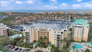 A hotel with multiple floors, a marina with boats, and a pool area. - Your Waterfront Retreat at Burnt Store Marina (Punta Gorda)