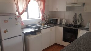 Unclassified image, 2 of 7, button - A comfortable livingroom, fully equipped kitchen make you feel at home apartment (Mossel Bay)