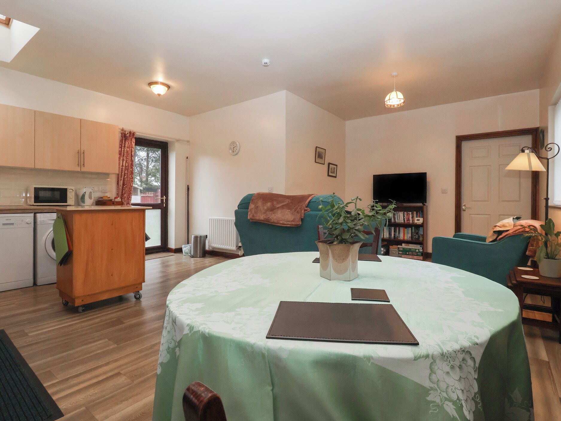 A compact living space with a kitchen, a dining area, and a seating area.