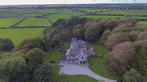 A large estate with a main house surrounded by expansive green fields and trees. - Tal Gwynedd (Llanfairpwllgwyngyll)
