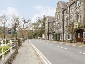 A stone building with a sign reading "Royal Oak Hotel" and a green sign indicating a restaurant nearby.