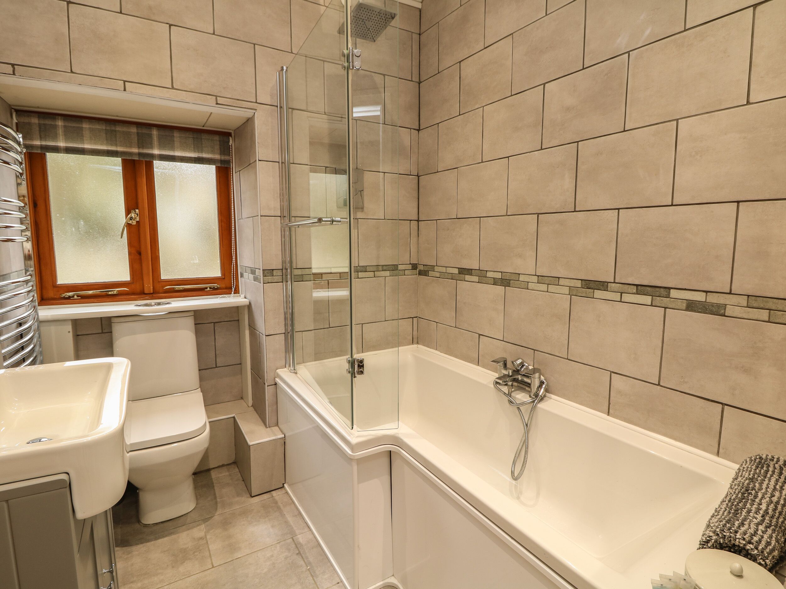 A bathroom with a bathtub, toilet, and shower.