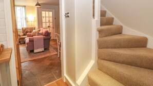 A staircase with carpeted steps leading to a second floor. - Chapel Cottage (Corbridge)