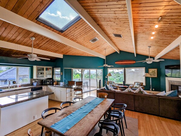 Relax in this inviting space with a central island, dining table, and comfortable seating area.