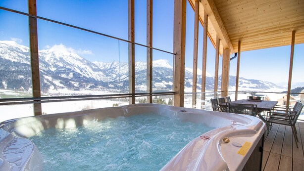 Ein Whirlpool mit Blick auf schneebedeckte Berge.