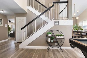 A staircase with a black railing, a WiFi sign, and a 'No Smoking' sign.