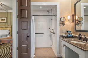 Enjoy a refreshing shower with a handheld and rain showerhead, plus ample storage for essentials.