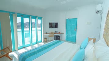 A bedroom with a bed, a desk, and a chair.