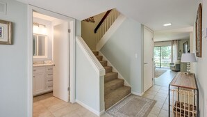 A home interior with a staircase, a kitchen area, and a living space.