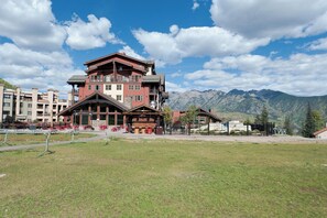 A multi-story hotel with a prominent red and beige facade, large windows, and a balcony area. - Penthouse in Purgatory Lodge - Ski in/Out - Awesome Deck and Views (Durango)