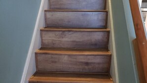 A wooden staircase with a handrail on the right side. - Historic Section of Sebring  Townhome (Sebring)