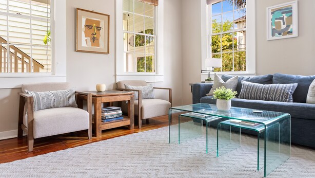 A living room with a sofa, armchairs, a coffee table, and a bookshelf. - 3 Blocks to King, Historic Home | The Garden Gates (Charleston)
