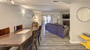 A modern living room with a dining area, a sofa, and a fireplace. - Short breaks in September and October live now! (Rehoboth Beach)