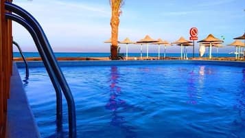 11 outdoor pools, open 9:00 AM to 5:00 PM, pool umbrellas, pool loungers